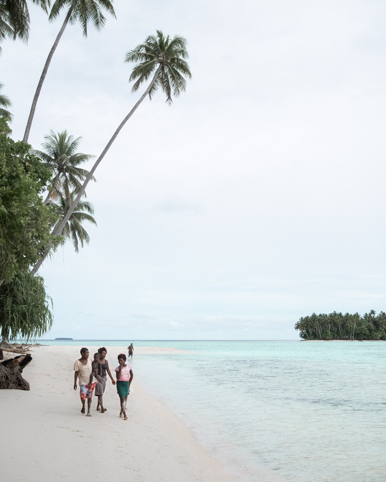 Family walking on the beach in Papua New Guinea