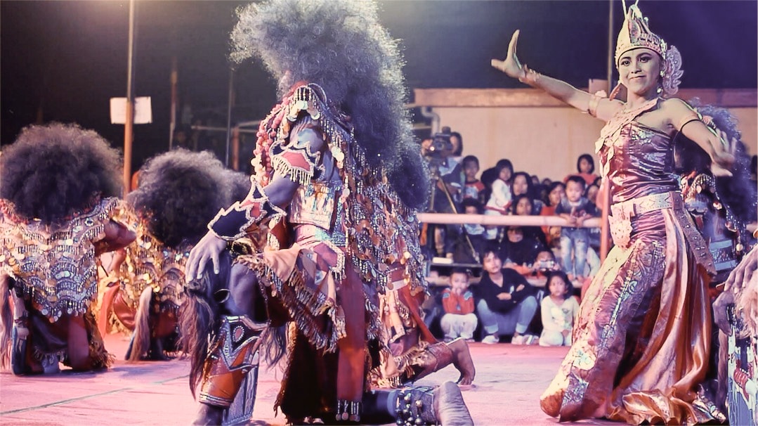A beautiful Javanese woman dancing in a red dress.