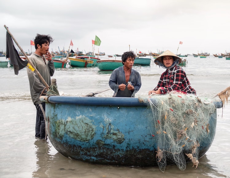 A fisherman family returning from the sea in Mui Ne, Vietnam
