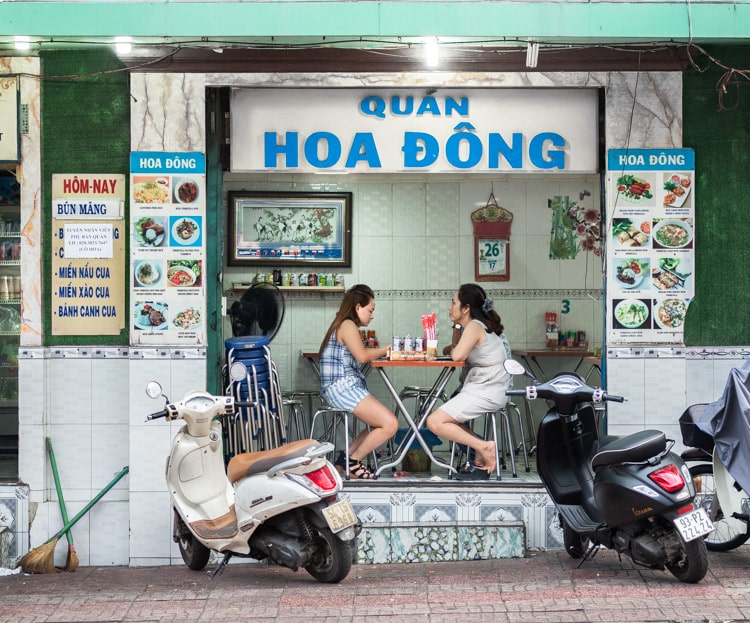 Ladies having lunch in the streets of Ho Chi Minh City, Vietnam